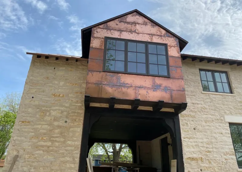 Copper metal panel facade on a stone building for Metal Roof Coating in Royse City